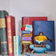 Handmade felt ornament featuring a miniature stack of colorful books, meticulously crafted from natural wool using traditional felting techniques. This eco-friendly and lightweight ornament adds a cozy, literary touch to holiday trees, bookshelves, or reading nooks. A charming gift for bookworms, teachers, and students, perfect for any occasion or year-round decor.
