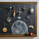 Handmade felt space shuttle ornament with beaded jet trail and embroidered rocket boosters, celebrating space exploration and STEM learning.