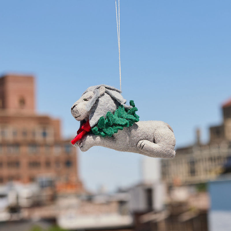 Handmade felt ornament of a regal lion statue adorned with a festive holiday wreath, inspired by the iconic lions outside the New York Public Library. Crafted from merino-blended wool, this ornament captures the spirit of NYC, literary tradition, and holiday cheer. A thoughtful gift for book lovers, librarians, and New York enthusiasts, perfect for trees, bookshelves, or desks. Ready to hang with a string attached.
