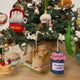 Hand-felted blueberry jam jar ornament with a gingham-style lid and a bunch of plump felt blueberries on top. Made from merino-blend wool, this 3-inch tall ornament is a charming, summer-inspired gift for bakers and brunch lovers. Perfect for cottagecore décor, holiday trees, or breakfast-themed bundles.  Hanging on a christmas trip.