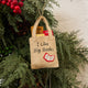 Handmade felt ornament shaped like a tote bag filled with miniature felt books, including titles like Pride & Prejudice and War & Peace. Crafted from soft merino-blended wool, this quirky ornament is a playful nod to literary humor. Perfect for bookworms, teachers, librarians, and pun enthusiasts, it adds a clever touch to holiday trees, bookshelves, or classrooms. Hanging from a Chrismas tree