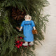 Handcrafted felt ornament of Jane Austen, featuring the beloved author standing with a feather quill in one hand and a felt copy of Pride and Prejudice in the other. She wears a period-style dress and bonnet, all made from natural merino-blend wool with fine stitched details. Includes a string for hanging and measures approximately 6 inches tall.