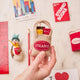 Handmade felt ornament shaped like The Strand Bookstore tote bag, complete with the embroidered red logo and a tiny felt NYC guidebook tucked inside. Crafted from soft tan wool felt, this miniature tote is filled with colorful hand-felted books, paying tribute to the legendary NYC bookstore. A perfect gift for Strand fans, NYC lovers, and book enthusiasts, adding a literary touch to holiday trees or bookshelves.

