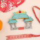 Hand-felted Chinatown Gate ornament with embroidered dragons, jade roof, and vermillion pillars inspired by Chinese architecture. Handmade and fair trade.