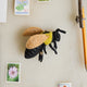 Hand-felted Eastern bumblebee ornament with beaded wings and golden pollen detail