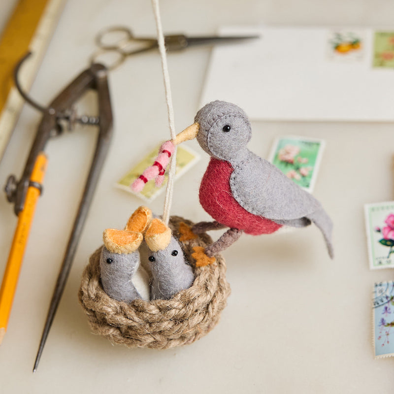 Handmade felt mama robin ornament feeding chicks in crocheted nest with embroidered details