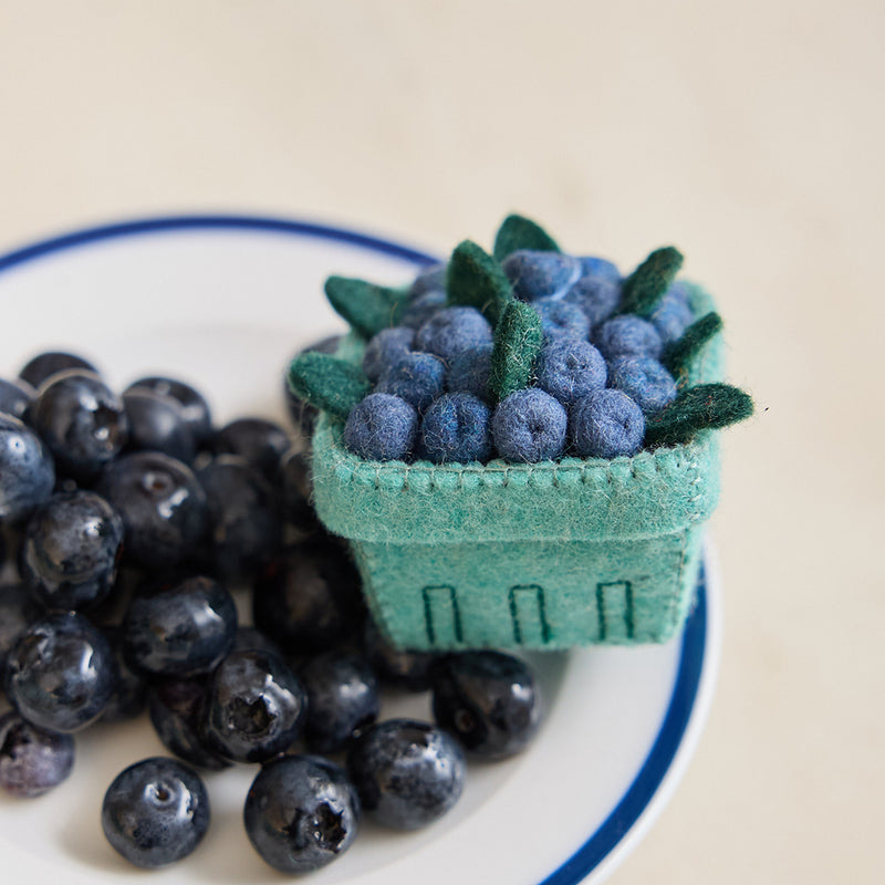 Felt blueberry pint ornament with hand-felted blue berries in a soft green wool basket. Handmade from natural wool felt using traditional needle-felting. Fair trade and ready to hang.