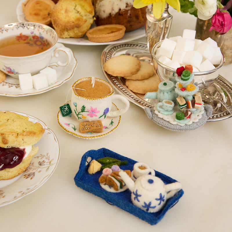 Hand-felted whimsical tea party ornament set with teacup and saucer, afternoon tea set, and tea tray. Handmade wool felt and fair trade.