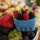 Hand-felted wool ornament of a pint-sized berry basket filled with vibrant raspberries and blackberries, accented with shimmering beadwork. Inspired by summer farmers’ markets and berry-picking days, this 2.25-inch tall ornament is perfect for seasonal displays or gifting to foodies, gardeners, and lovers of handmade summer charm.