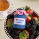 Hand-felted blueberry jam jar ornament with a gingham-style lid and a bunch of plump felt blueberries on top. Made from merino-blend wool, this 3-inch tall ornament is a charming, summer-inspired gift for bakers and brunch lovers. Perfect for cottagecore décor, holiday trees, or breakfast-themed bundles.