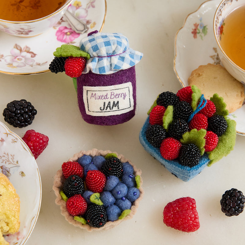 Hand-felted mixed berries ornament set featuring jam jar, berry pint, and tart with beaded raspberries, blackberries, and blueberries. Handmade wool felt.
