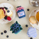 Hand-felted blueberry jam jar ornament with a gingham-style lid and a bunch of plump felt blueberries on top. Made from merino-blend wool, this 3-inch tall ornament is a charming, summer-inspired gift for bakers and brunch lovers. Perfect for cottagecore décor, holiday trees, or breakfast-themed bundles.