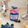Hand-felted blueberry jam jar ornament with a gingham-style lid and a bunch of plump felt blueberries on top. Made from merino-blend wool, this 3-inch tall ornament is a charming, summer-inspired gift for bakers and brunch lovers. Perfect for cottagecore décor, holiday trees, or breakfast-themed bundles.
