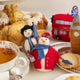 London snowman felt ornament wearing a black top hat and Union Jack tie, holding a teacup and umbrella. Handmade wool Christmas ornament with British charm. Fair trade and ready to hang. Featured with a Lady Snowwoman