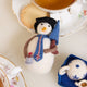 London snowman felt ornament wearing a black top hat and Union Jack tie, holding a teacup and umbrella. Handmade wool Christmas ornament with British charm. Fair trade and ready to hang.