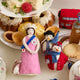 A British ornament collection featuring Young Queen Elizabeth II felt ornament in gala attire with a loyal corgi at her side. Handmade wool Christmas ornament honoring British royalty. Fair trade and ready to hang.