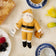 Handcrafted felt Santa bee ornament holding honey jar, supporting pollinator education