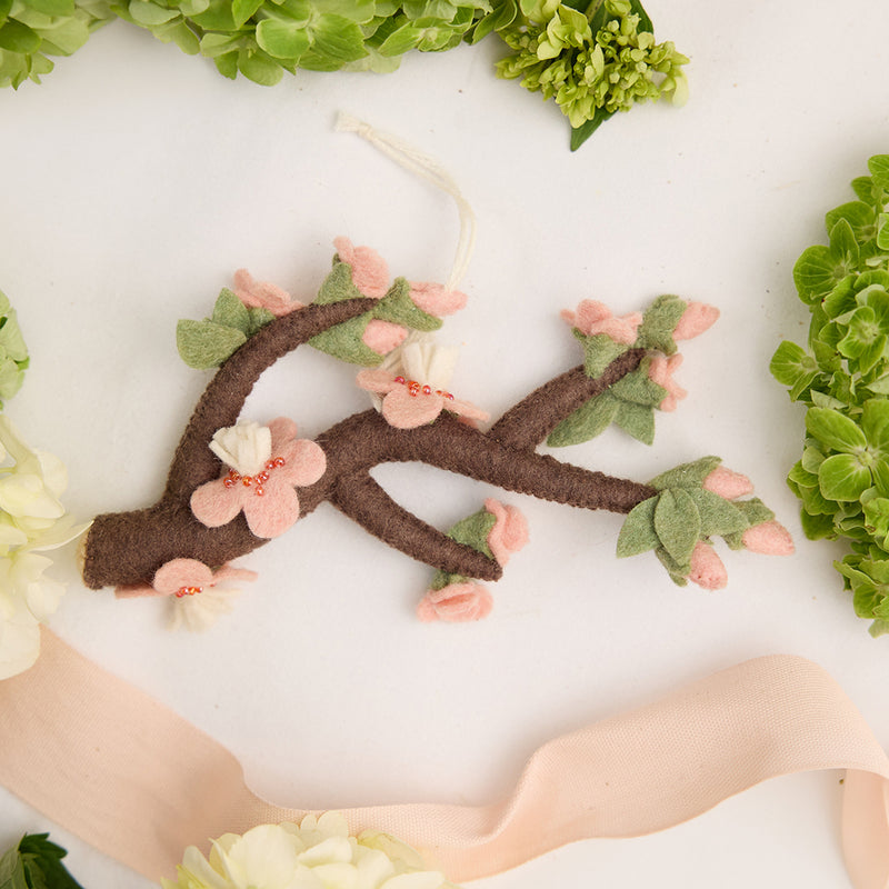 Hand-felted sakura cherry blossom branch ornament with pink wool flowers, inspired by Japanese spring. Ethically handmade and fair trade.