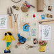 Fair trade felt Mama Bluebird ornament hanging from a botanical tree – spring-inspired handmade decor.