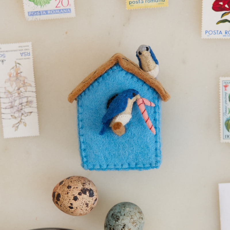 Fair trade birdhouse ornament crafted in Kyrgyzstan from natural wool, part of a garden-inspired ornament collection featuring birds, bees, and blossoms