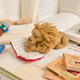 Handmade felt ornament of a wise lion wearing tiny felt glasses, absorbed in a large red book. Crafted from natural wool, this charming lion adds a storybook touch to holiday trees, reading nooks, or cozy corners. A delightful gift for readers, teachers, librarians, or anyone who loves books and imagination. Each ornament is unique, crafted with care using traditional felting techniques.