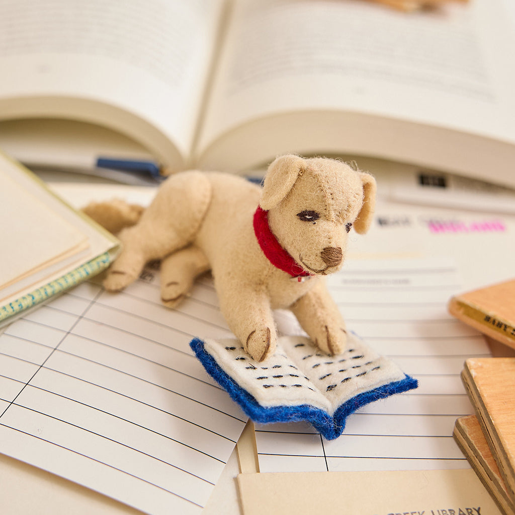 Charming wool felt ornament featuring a loyal pup reading a book – part of the Reading Collection for bookworms, teachers, and story lovers.
