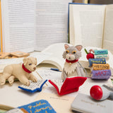 Whimsical reading dog and cat ornaments crafted from natural wool – perfect for celebrating the quiet joy of reading and story time rituals.