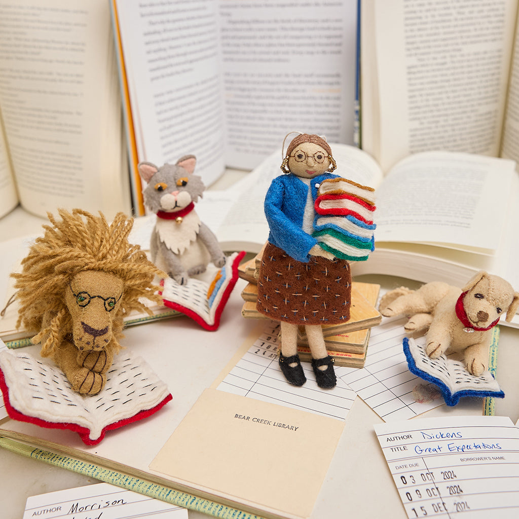 Natural wool librarian ornament with glasses and a book stack – celebrating the love of books and the magic of reading, from our Reading Collection. Pictured here with lots of reading animal friends
