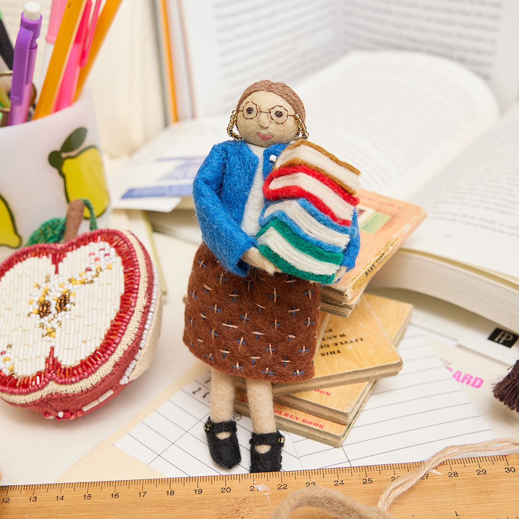 Handcrafted felt ornament from Craftspring of a smiling librarian holding books, from the Reading Collection – a tribute to the keepers of stories, perfect for readers, teachers, and literary hearts.