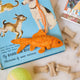 Handmade felt Goldfish ornament from Craftspring, featuring intricate beaded and embroidered details—displayed on a book about pets with pet toys and treats, perfect for animal lovers and festive holiday gifting, ethically crafted by artisans using sustainable wool.