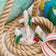 Handmade felt Anchor ornament from Craftspring, featuring beaded barnacles, appliqué seaweed and starfish, and draped in netting—displayed with rope and lobster buoys, perfect for nautical holiday decor and gifting, sustainably handmade by artisans using wool.