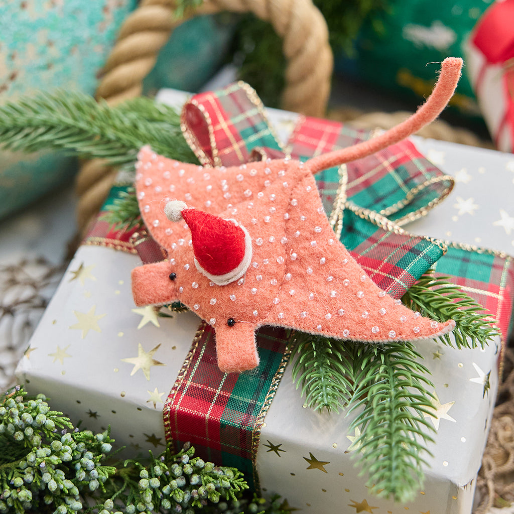 Handmade felt Santa Coral Manta ornament from Craftspring, featuring intricate beaded and embroidered details and a festive Santa hat—displayed on a Christmas gift for a whimsical coastal holiday scene, ethically crafted by artisans using sustainable wool.