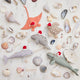 Handmade felt Santa Manatee, Santa Spyhop Gray Whale, Santa Neutral Sea Turtle, Santa Coral Manta, and Santa Gray Blue Narwhal ornaments from Craftspring—each featuring festive Santa hats and intricate beaded and embroidered details, displayed among shells for a joyful coastal Christmas scene, ethically crafted by artisans using sustainable wool.