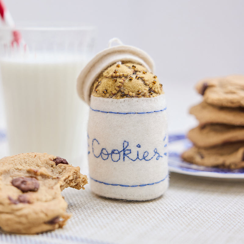Handmade felt Cookie Jar ornament from Craftspring, featuring chocolate chip cookies with embroidered and beaded details—displayed with milk and cookies, perfect for cozy Christmas decorating and sweet holiday gifting, ethically crafted by artisans using sustainable wool.