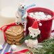 Handmade felt Chilly Polar Bear and Little Drop Polar Bear ornaments from Craftspring—featuring a white polar bear with a cozy blue scarf and a polar bear wearing a Santa hat and green scarf, displayed with hot cocoa, cookies, and evergreen branches, perfect for cozy Christmas moments and festive gifting, ethically crafted by artisans using sustainable wool.