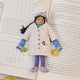 Craftspring’s handmade felt Young Scientist Christmas ornament displayed on an open science book—perfect for thoughtful holiday gifting, showcasing intricate beaded and embroidered details that inspire curiosity and learning, ethically crafted by artisans using sustainable wool.