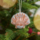 Craftspring’s Scallop Shell Ornament displayed on a Christmas tree — made of satin with intricate beaded and embroidered details, adding coastal holiday charm and gifting warmth, ethically crafted by artisans.