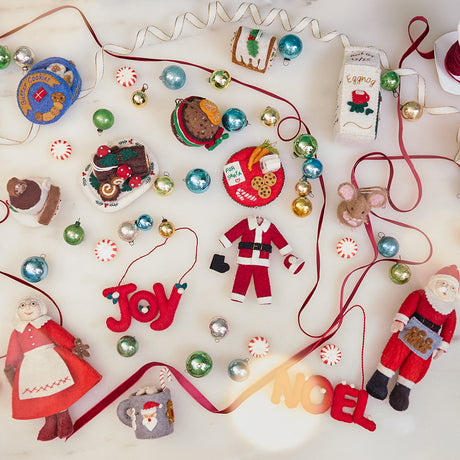 Collection of Christmas ornaments  including cookie ornaments, eggnog ornament, buche de noel ornament, pannatone, and ornaments of Santa and Mrs. Clause  - full of sugar and spice charm.