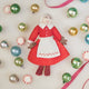 Felt Mrs. Clause ornament in a red dress surrounded by colorful Christmas ornaments. Holiday Joy filled with sugar and spice