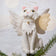 Handmade felt Angel Cat Tree Topper from Craftspring, featuring white angel wings, a halo, a white collar with a bell, and gold embroidered details—displayed on a Christmas tree, perfect for whimsical holiday decorating and thoughtful gifting, ethically crafted by artisans using sustainable wool.