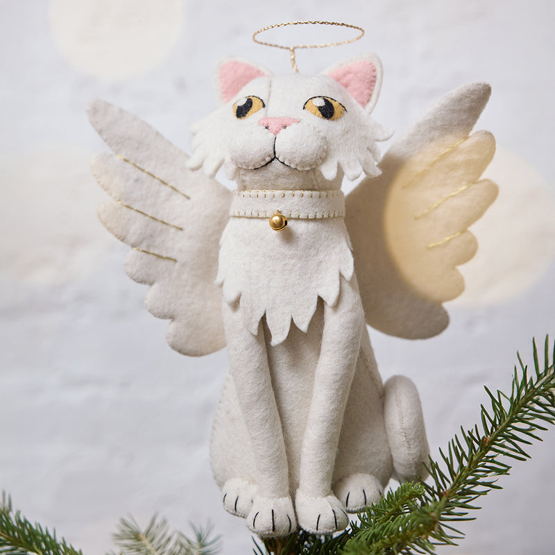 Handmade felt Angel Cat Tree Topper from Craftspring, featuring white angel wings, a halo, a white collar with a bell, and gold embroidered details—displayed on a Christmas tree, perfect for whimsical holiday decorating and thoughtful gifting, ethically crafted by artisans using sustainable wool.