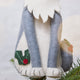 Close-up of the handmade felt Gray Cat Tree Topper from Craftspring, showing soft white paws and appliqué holly with embroidered details—perfect for festive cat lovers and thoughtful holiday gifting, ethically crafted by artisans using sustainable wool.