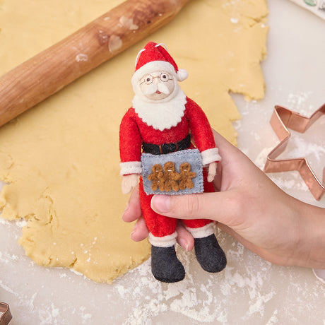 Santa’s baking gingerbread! Ethically handmade felt ornament full of vintage charm—perfect for cookie lovers and cozy Christmas memories.