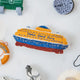 Craftspring’s handmade felt Staten Island Ferry ornament — featuring intricate embroidered details and beaded waves on the iconic orange ferry, displayed surrounded by the NYC Mini Ornaments Set of 24 for a festive holiday scene, perfect for Christmas decorating or gifting, ethically crafted by artisans using sustainable wool.