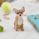 Craftspring’s needle-felted Chihuahua Ornament with big ears and a cute face, displayed among dog treats and toys — a playful and charming holiday decoration, perfect for gifting, ethically crafted by artisans using sustainable wool.