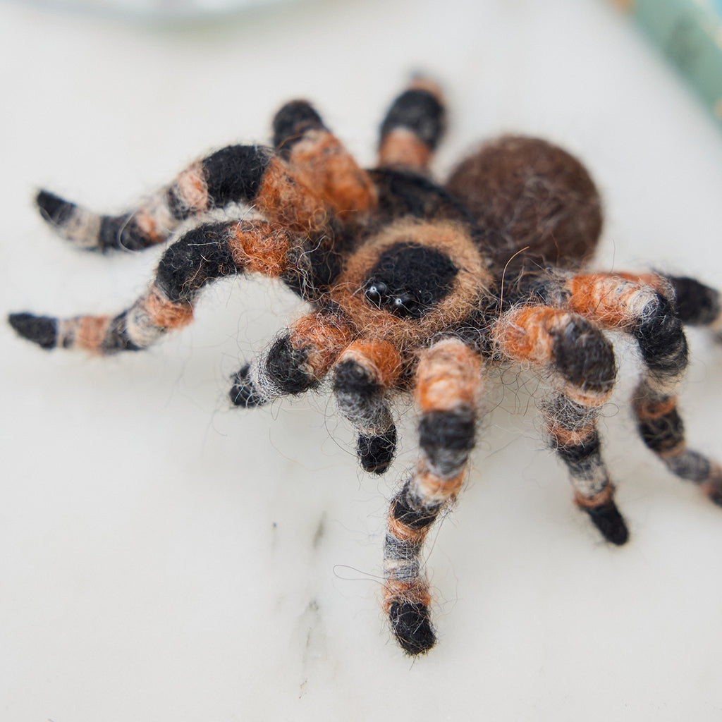 Close-up of Craftspring’s needle-felted Tarantula Ornament — highlighting the intricate felted body, hairy legs, and beaded eyes, showcasing the playful and spooky craftsmanship, ethically crafted by artisans using sustainable wool.