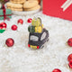 Craftspring’s handmade felt London Black Cab ornament — featuring beaded and embroidered details with festive presents on top of the car and holly accents, displayed in snow with Christmas baubles and treats for a joyful holiday scene, perfect for Christmas decorating or gifting, ethically crafted by artisans using sustainable wool.