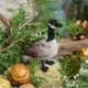Craftspring’s Canada Goose Ornament — handmade with soft wings and beaded eyes — nestled on moss among golden walnuts and evergreens, evoking the cozy magic of holiday traditions and Christmas gifting — heirloom-quality decor, ethically crafted by artisans using sustainable wool.