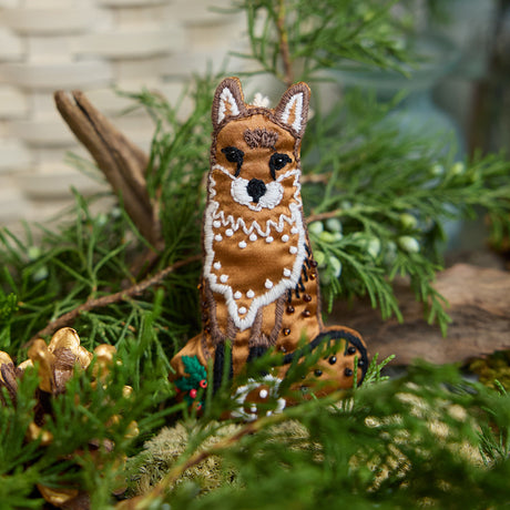Craftspring’s handmade satin Fox Beaded Ornament — featuring intricate beaded and embroidered details, displayed nestled among evergreens for a cozy woodland holiday scene, perfect for Christmas decorating or gifting, ethically crafted by artisans using sustainable materials.