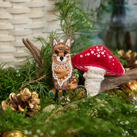 Craftspring’s handmade satin Fox Beaded and Mushroom Beaded ornaments — featuring intricate beaded and embroidered details, displayed nestled among evergreens for a cozy woodland holiday scene, perfect for Christmas decorating or gifting, ethically crafted by artisans using sustainable materials.